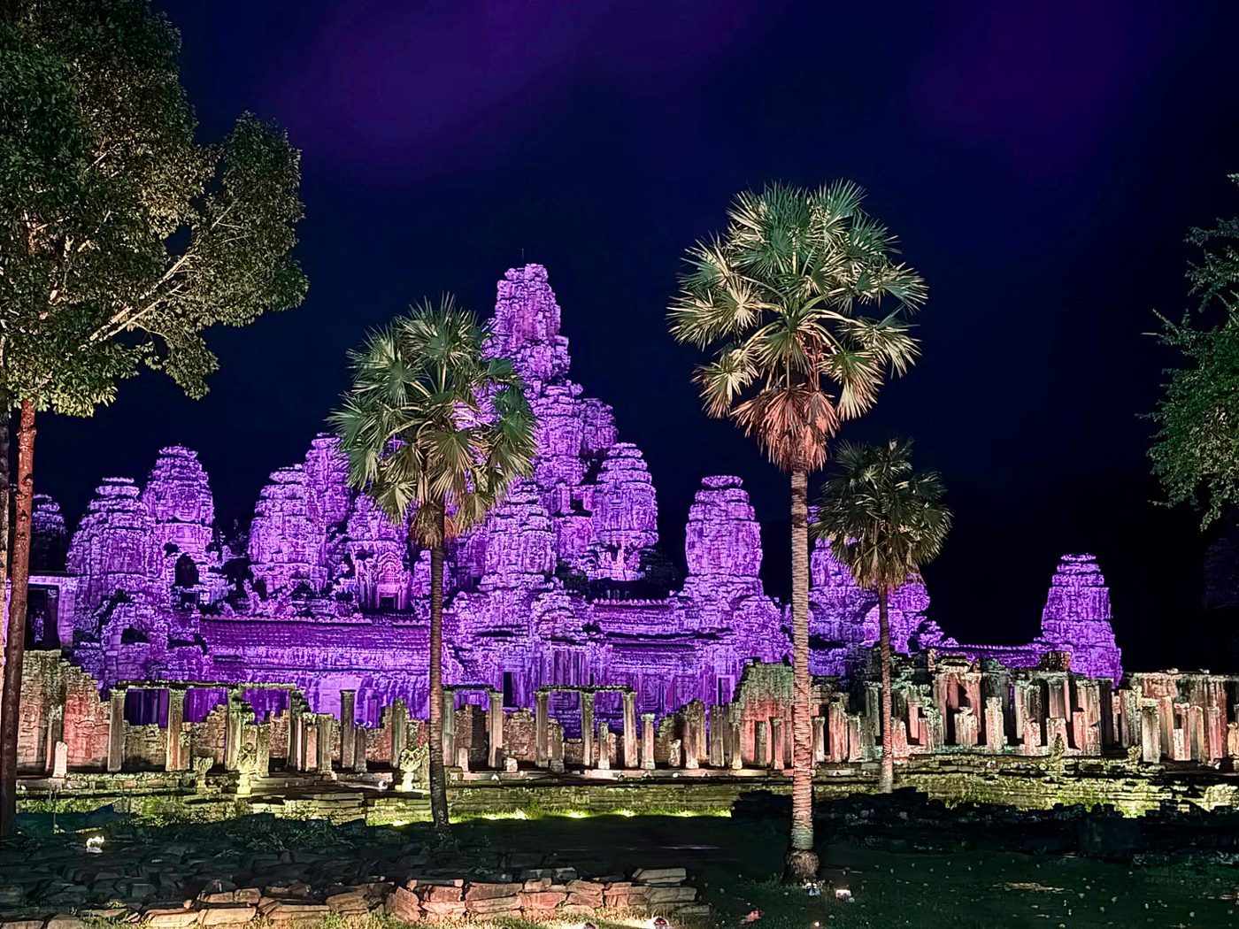 Bayon Temple at Angkor Thom, lit in G Adventures' signature purple for the GX closing ceremony.